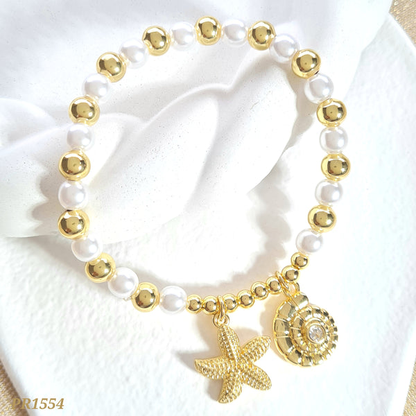 Pulsera perlas y balines dije estrella y caracol PR1554